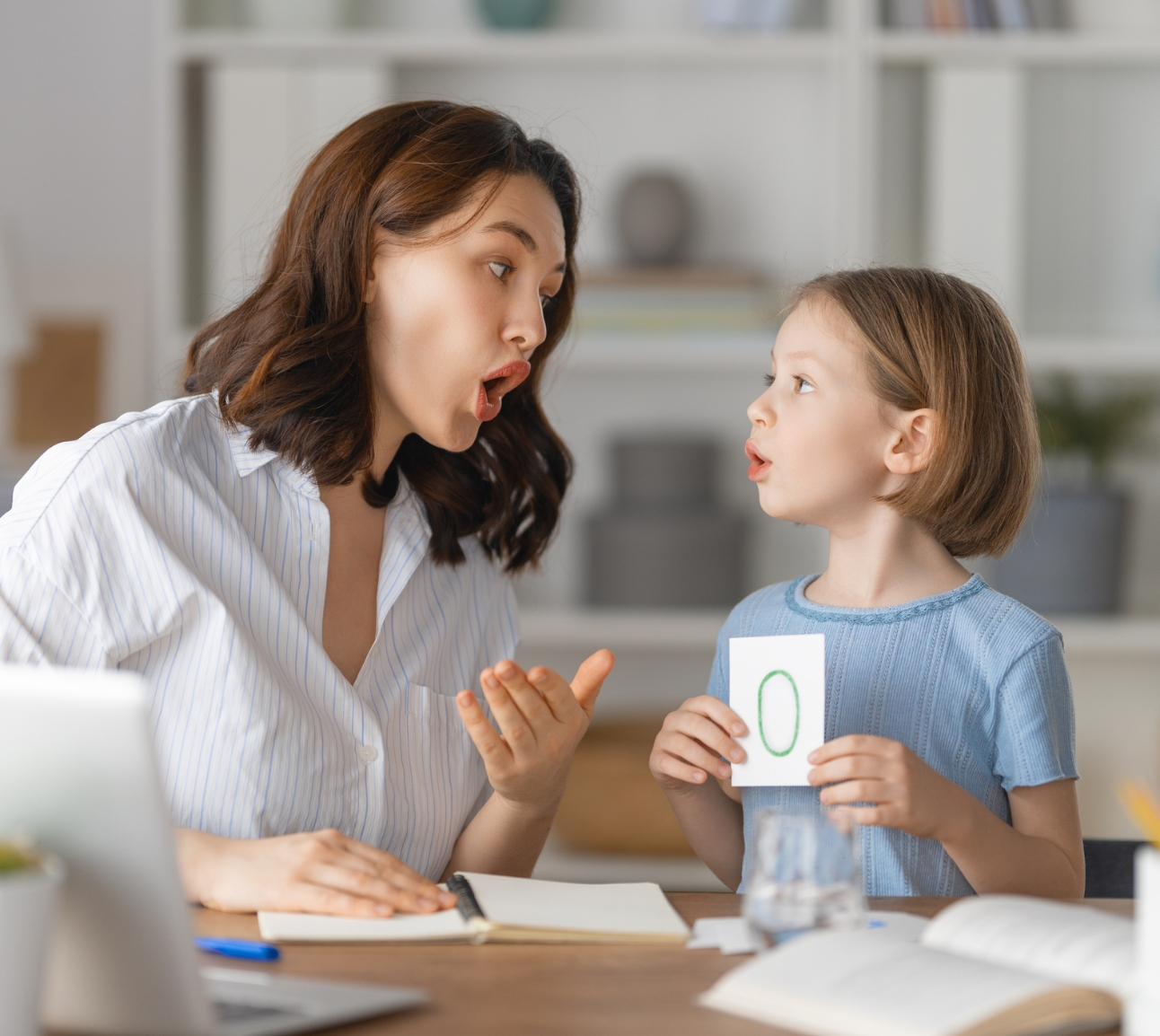 child in speech therapy practicing the letter o